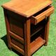 Golden oak bedside table topped with a moulded shelf niche with a shelf from the 1930s.