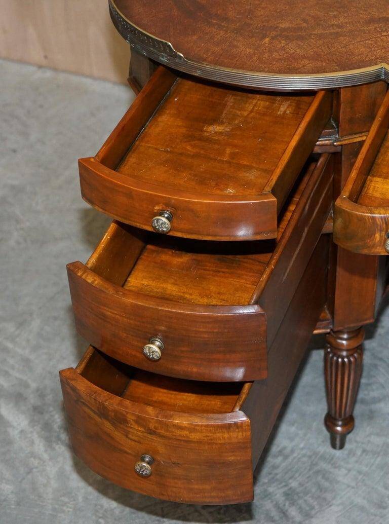 Regency style hardwood and leather kidney desk with gallery.