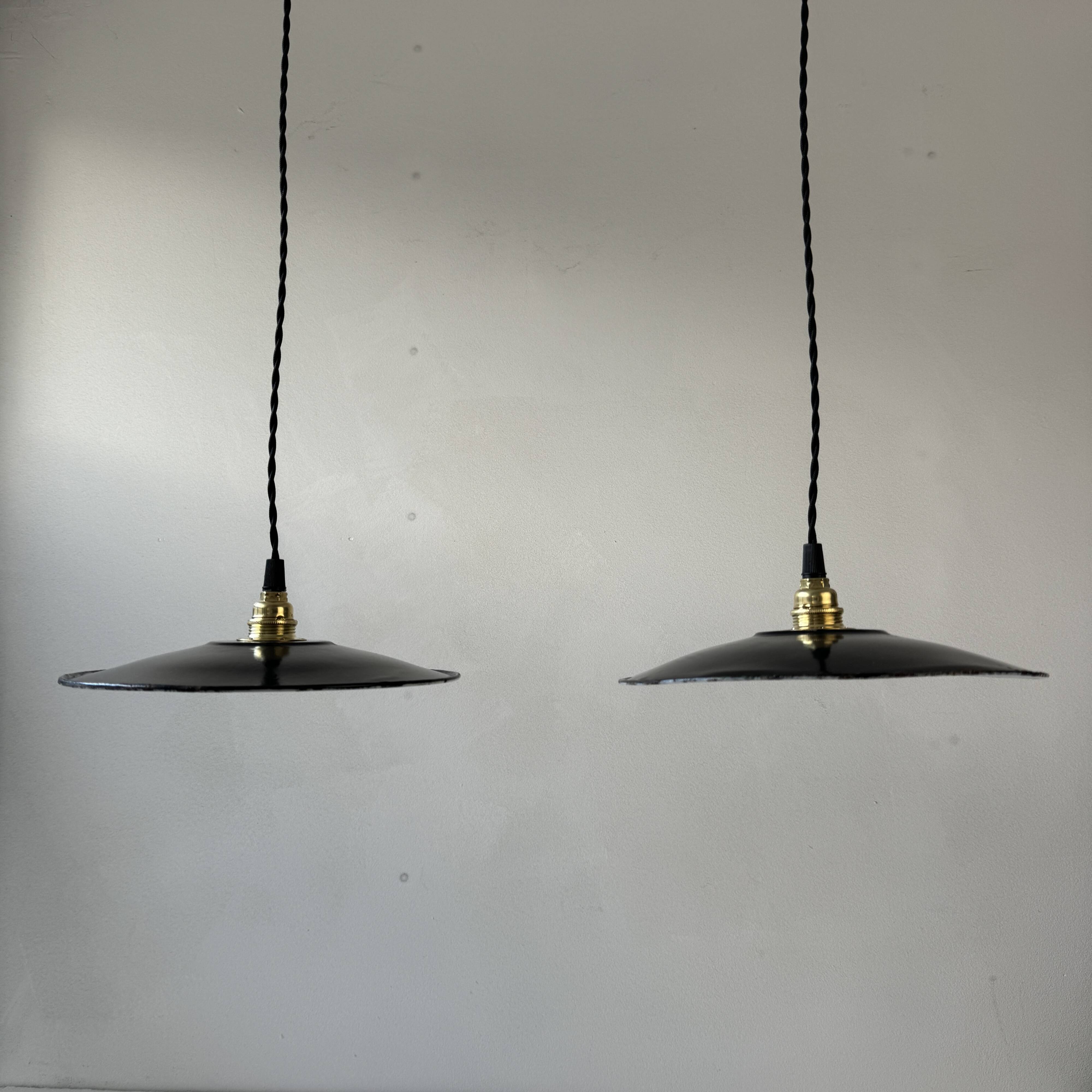 Pair of old industrial black enamelled pendant lights