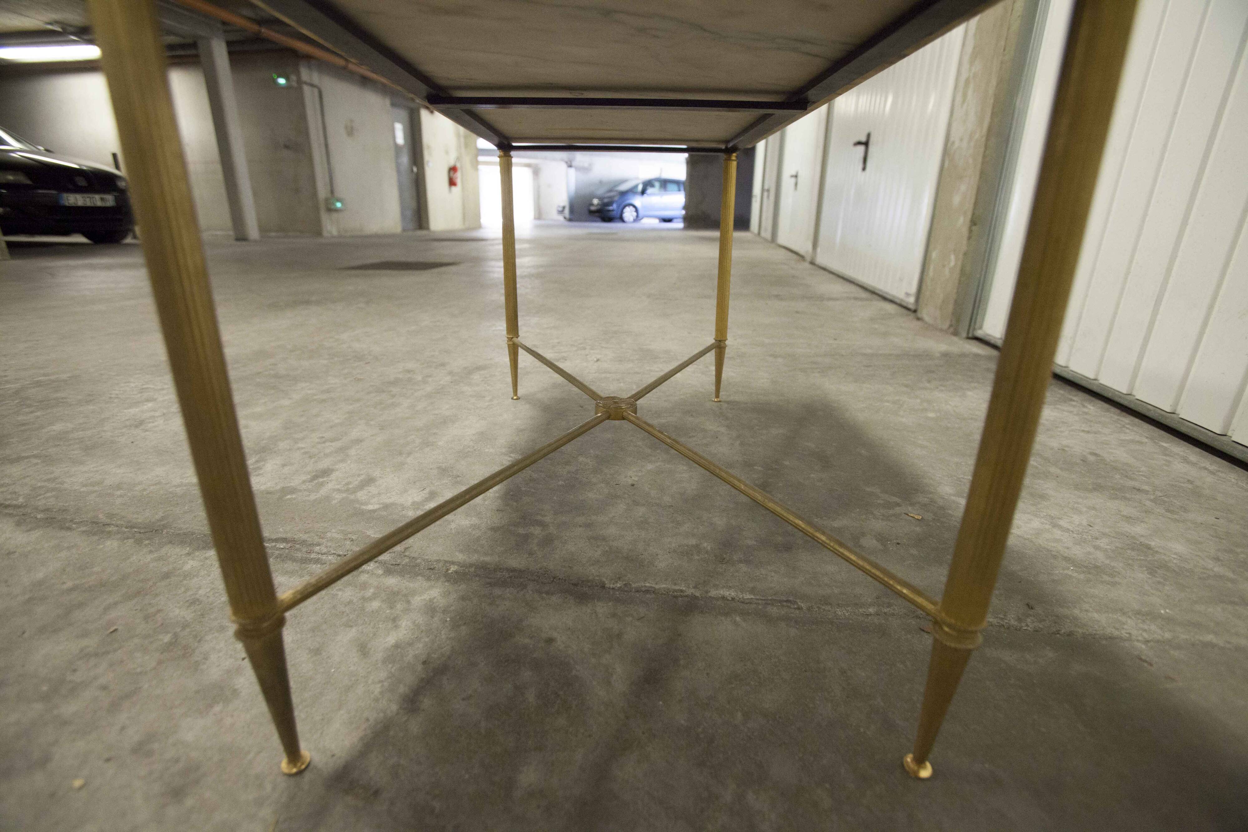 Marble coffee table with brass legs, height 46 cm.