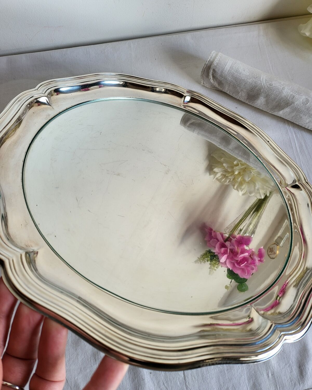 Round silver-plated serving dish with a glass base.