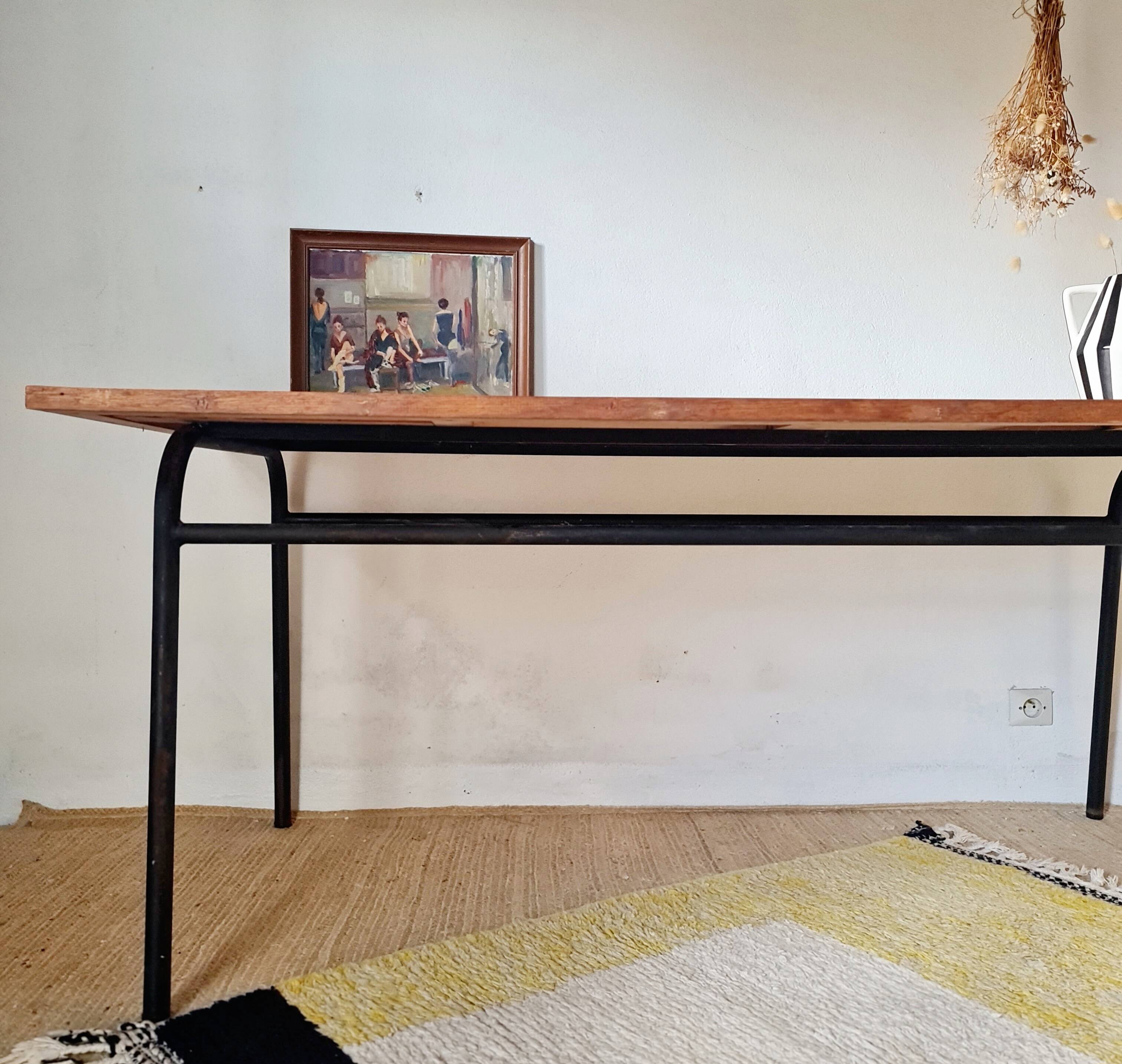 Metal tubular base table with a wooden top.