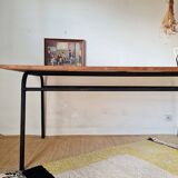 Metal tubular base table with a wooden top.