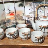 Asian set of a teapot and its cups