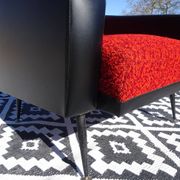 Pair of vintage armchairs in black faux leather and red fabric.