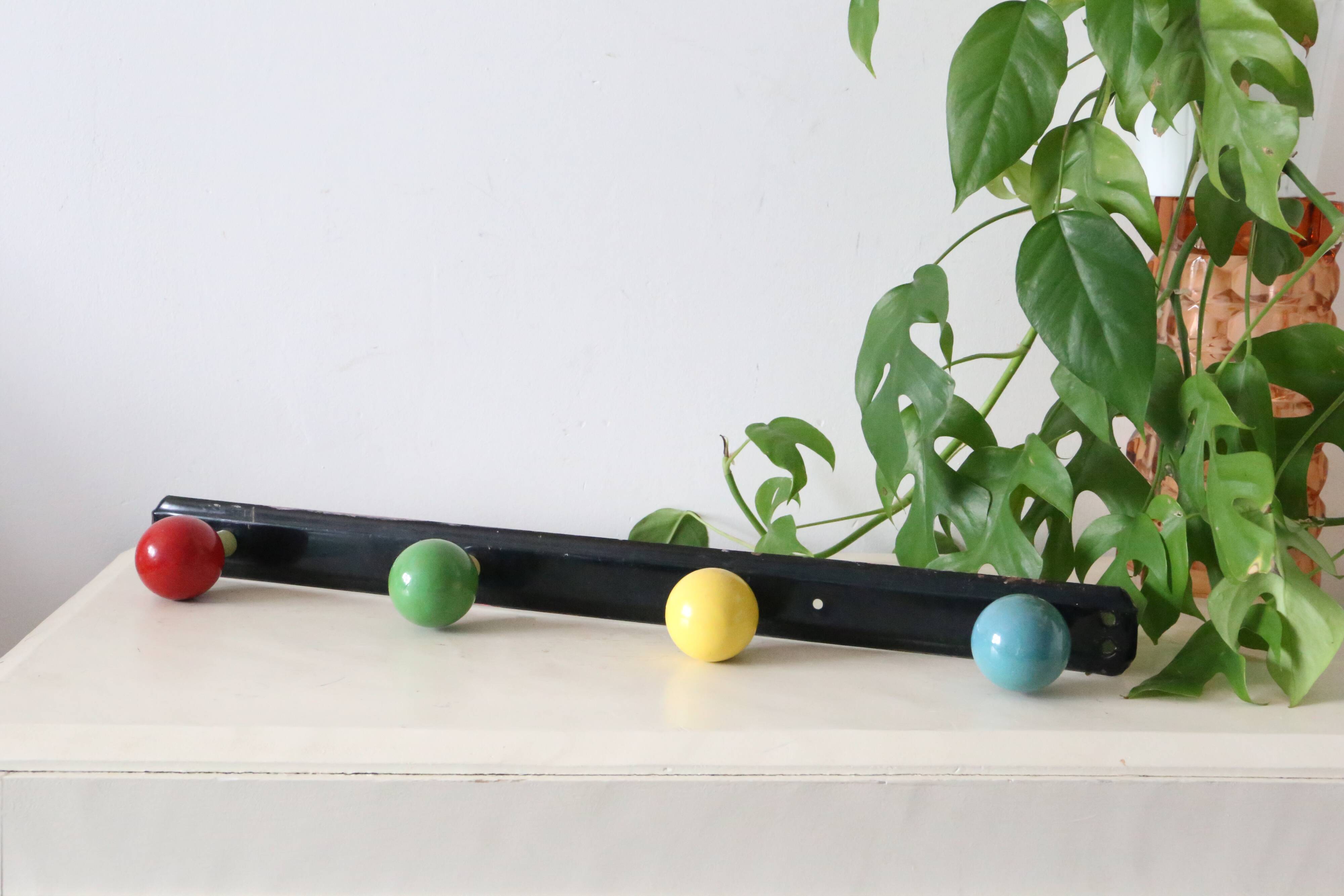 Wall-mounted coat rack, metal and colored wooden hook, 1960