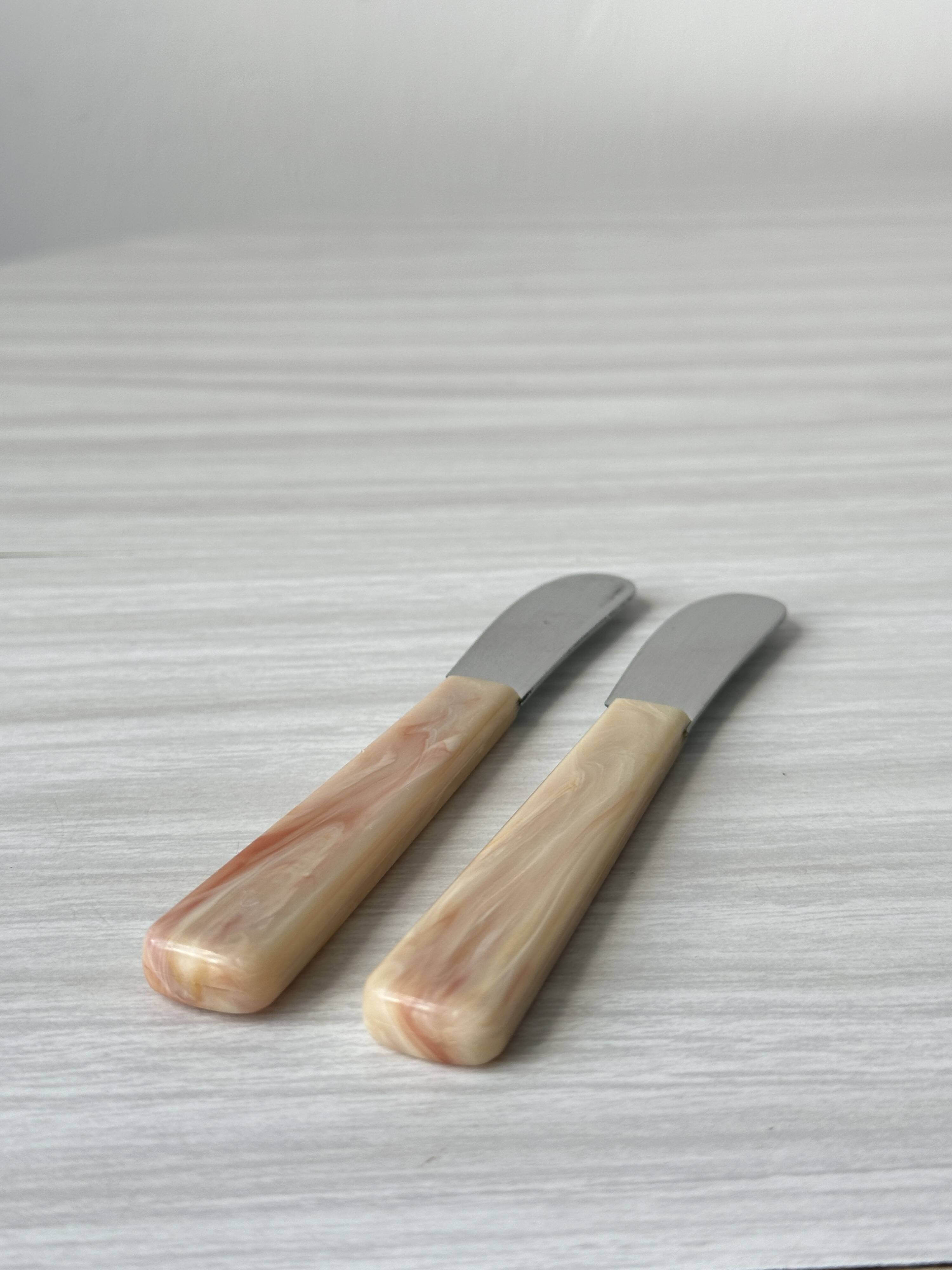 Pink bakelite butter knives.