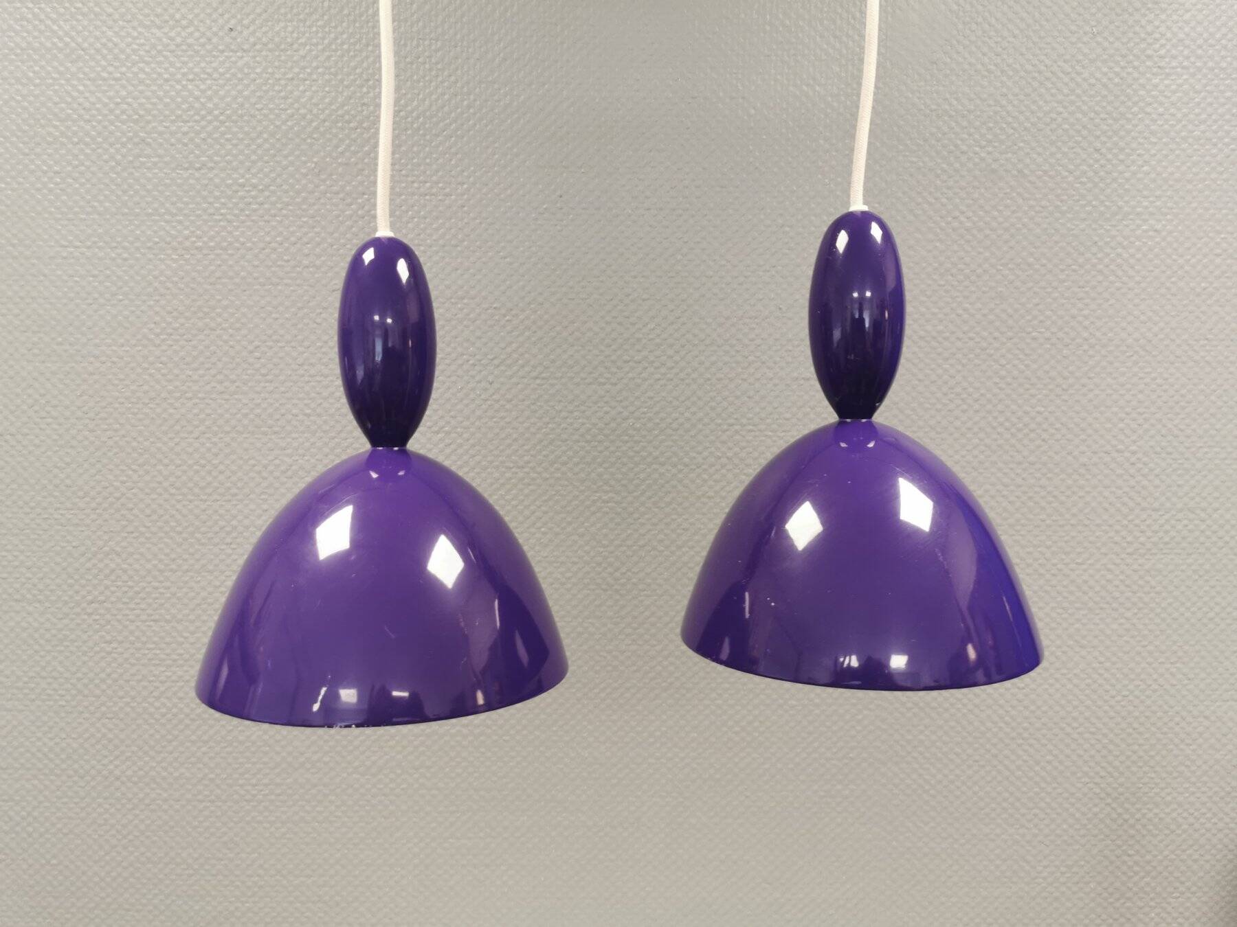 Two purple hanging lamps from Norway Says for Muuto, model Mhy