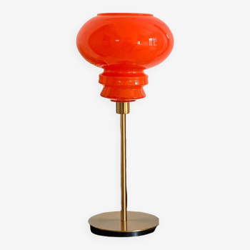 Table lamp made with a vintage orange glass lampshade and a gold base