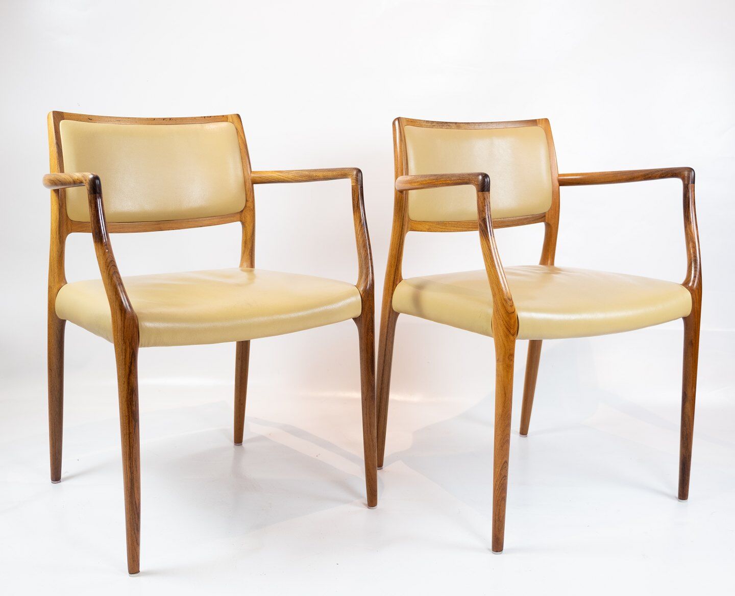 Pair of N.O. Moeller armchairs, model 65, in rosewood and light leather