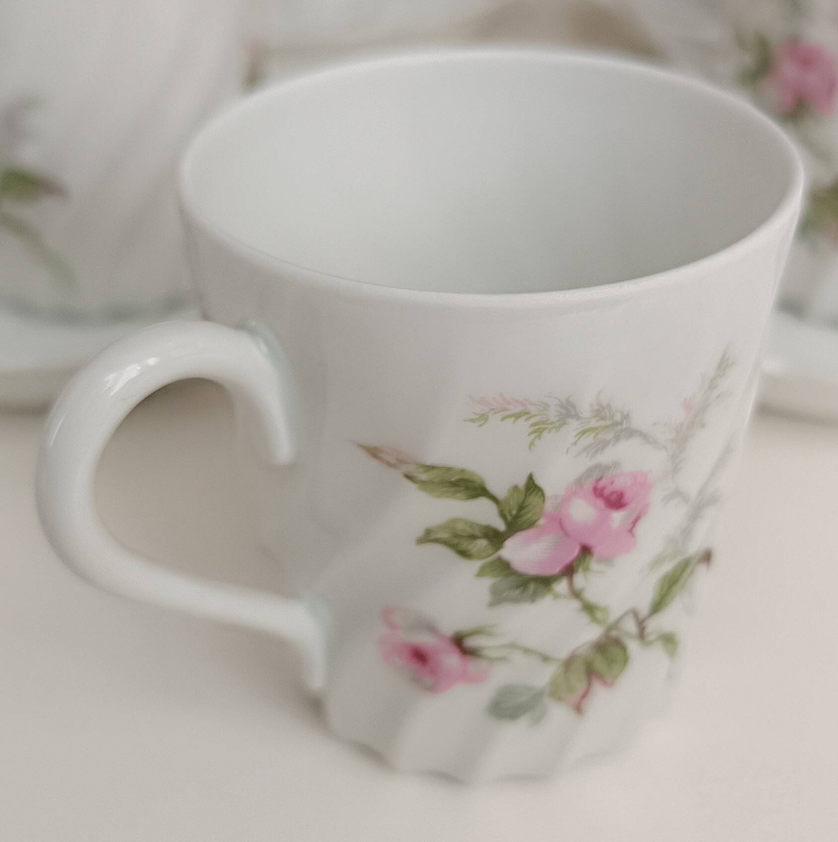 Haviland Limoges porcelain 10 coffee cups and 9 saucers with floral decoration.