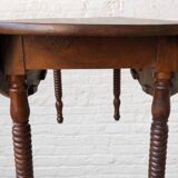 Oval walnut table with flaps