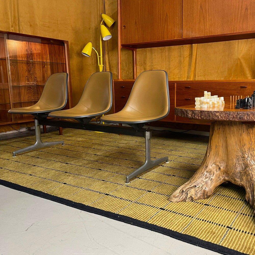 Tandem bench with brown Naugahyde pad shell chairs by Charles and Ray Eames for Herman Miller