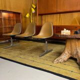 Tandem bench with brown Naugahyde pad shell chairs by Charles and Ray Eames for Herman Miller