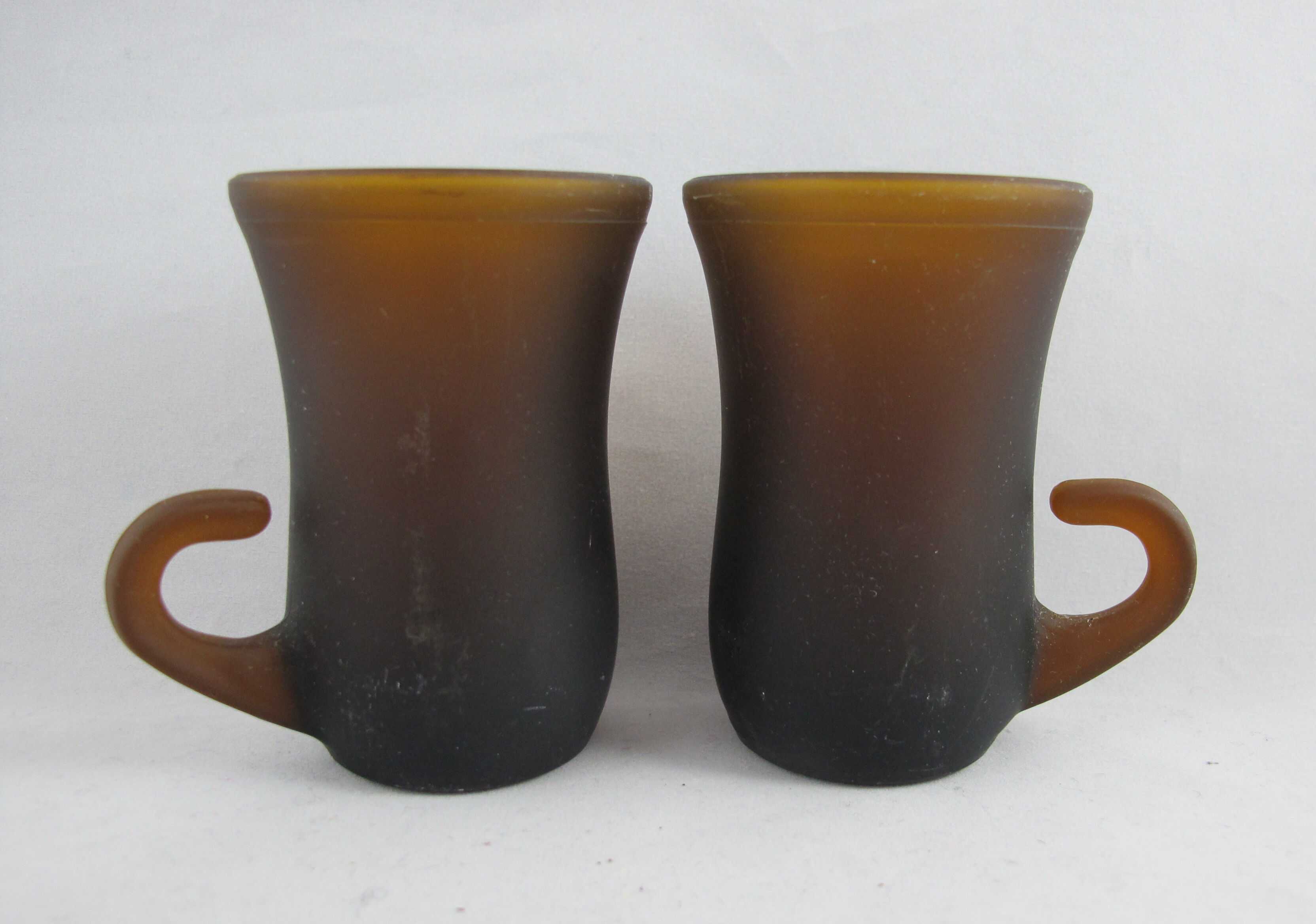 pair of small brown glass cups