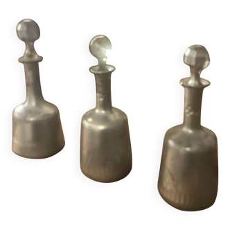 Set of 3 antique pewter bottles with cut glass stoppers.