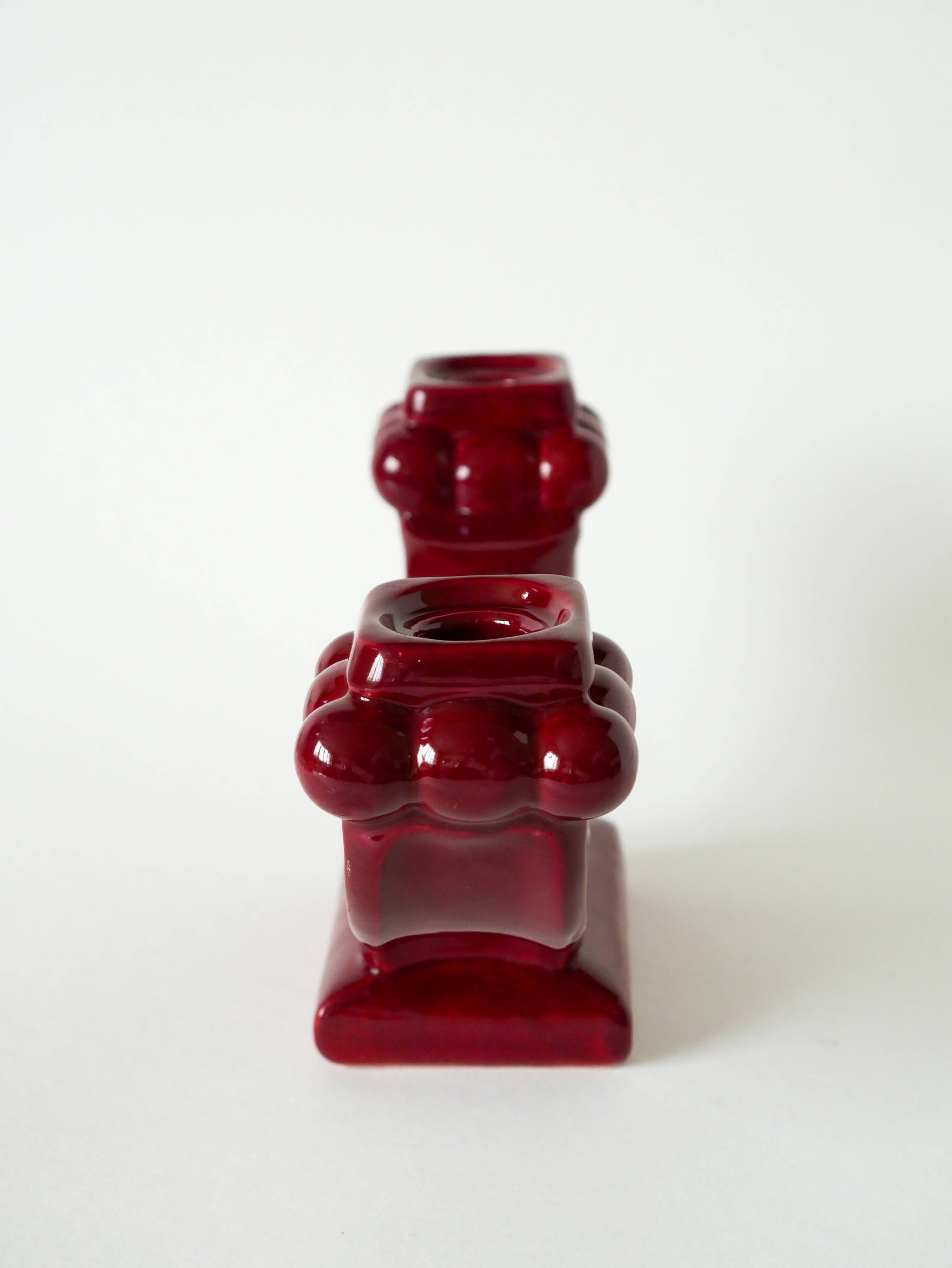 Pair of large burgundy ceramic candlesticks, 1950
