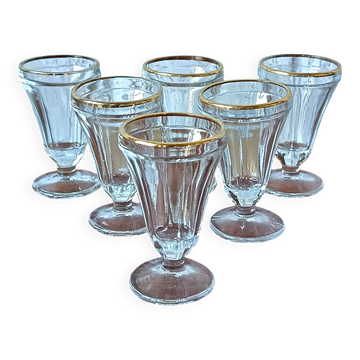 Antique footed liqueur glasses with gold trim from the early 20th century.