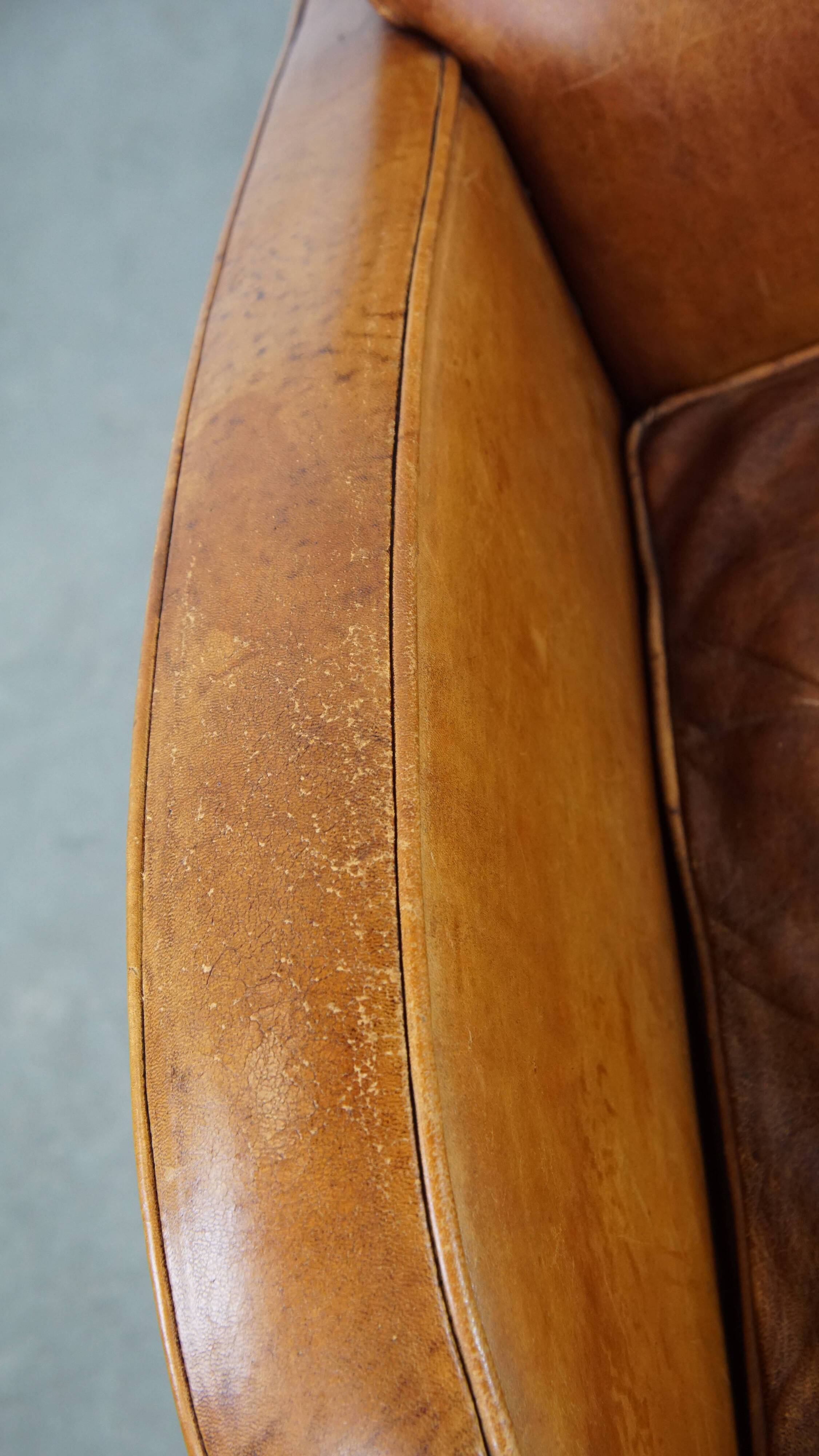 Characteristic sheepskin design armchair in beautiful warm cognac colours