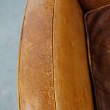 Characteristic sheepskin design armchair in beautiful warm cognac colours