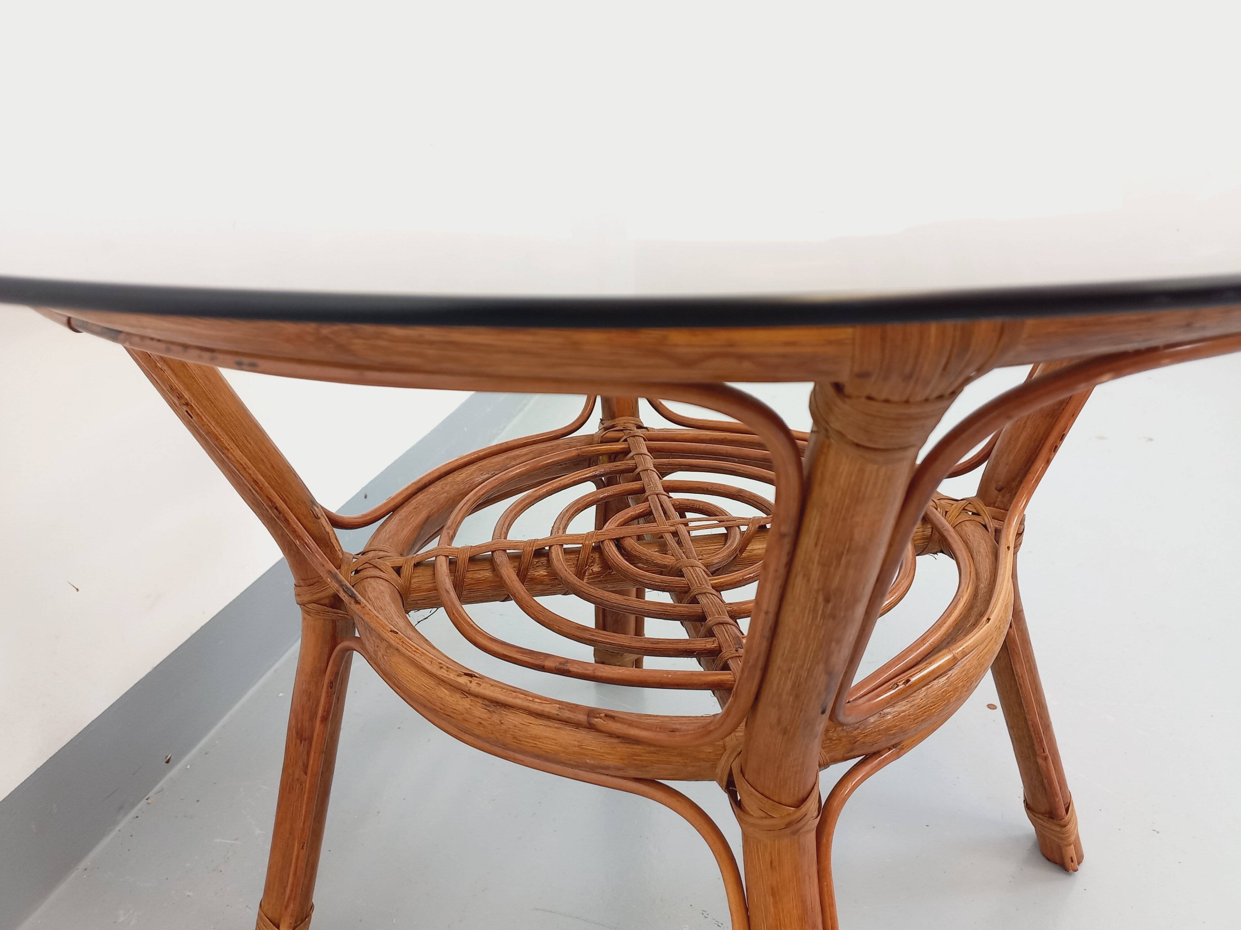 Vintage round smoked glass and rattan coffee table from the 70s