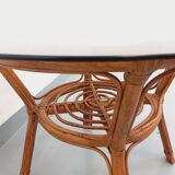 Vintage round smoked glass and rattan coffee table from the 70s