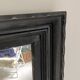 1950s mirror, matte black wood with a patina.