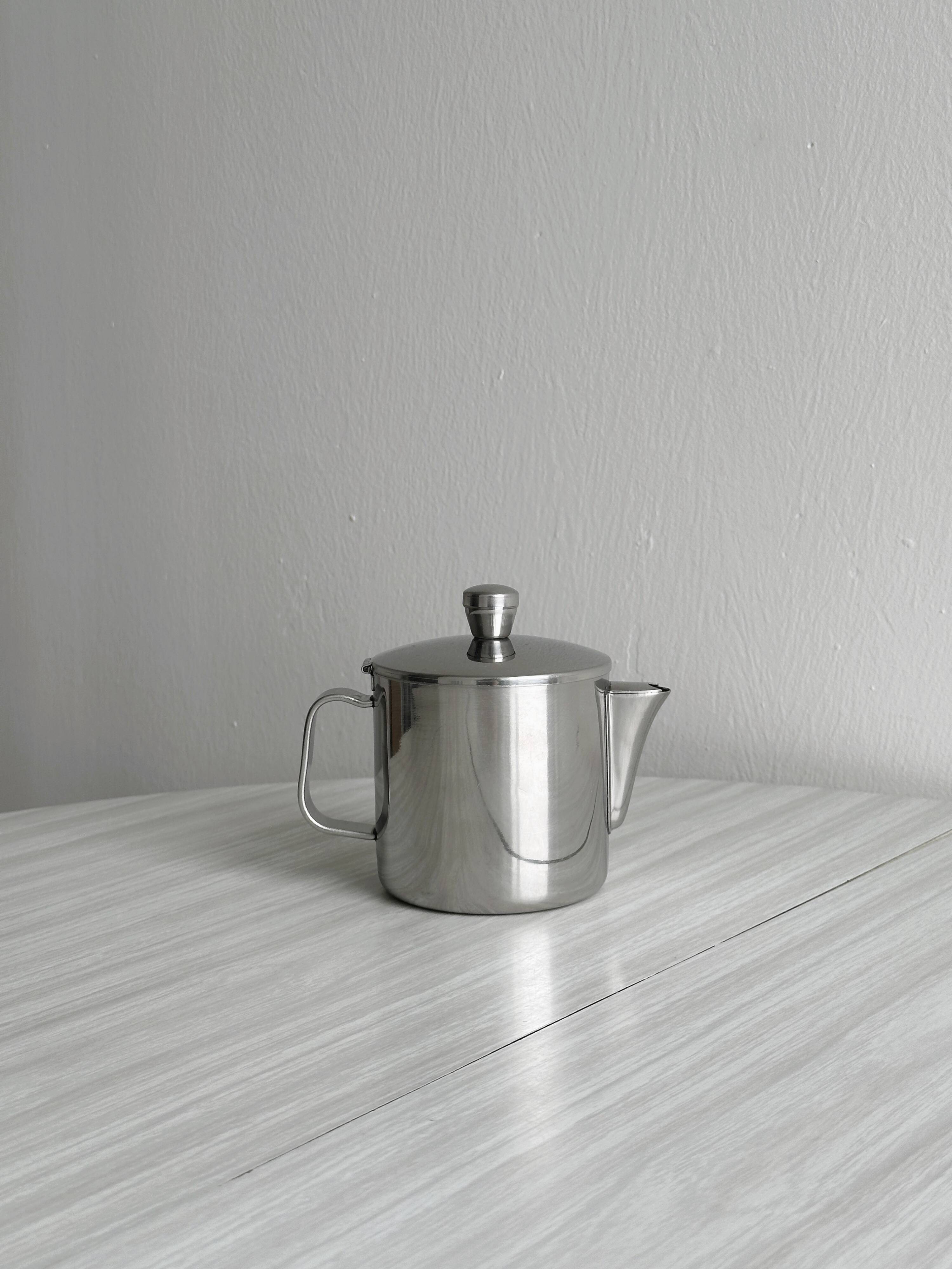 Small shiny stainless steel teapot