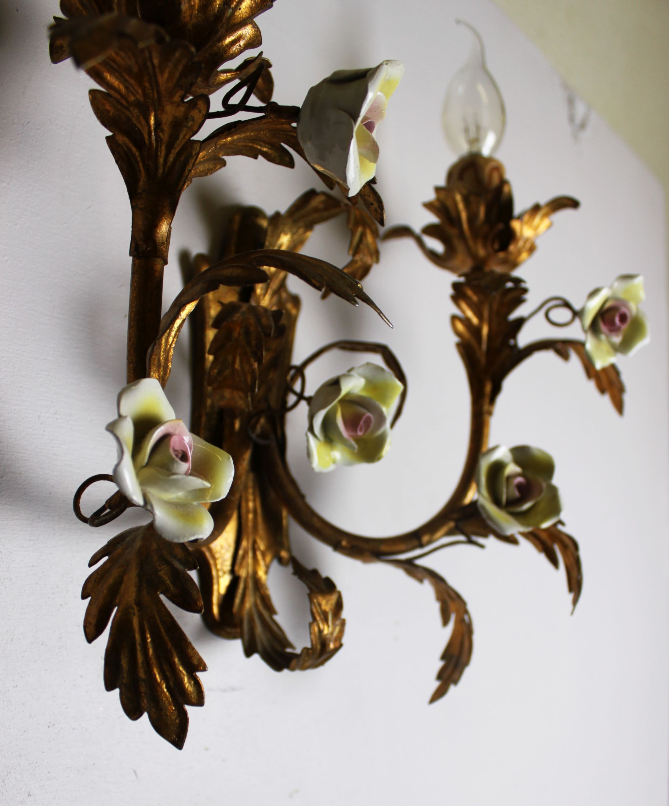 Pair of gold wall sconces with porcelain flowers