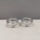 A set of iittala candle holders in clear transparent glass.
