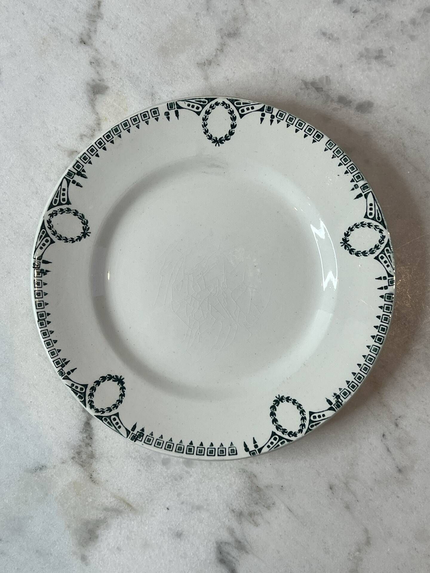 Set of 2 Saint Amand plates with laurel crown decoration.