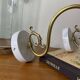 Large pair of brass swan neck wall lights with transparent glass globes.