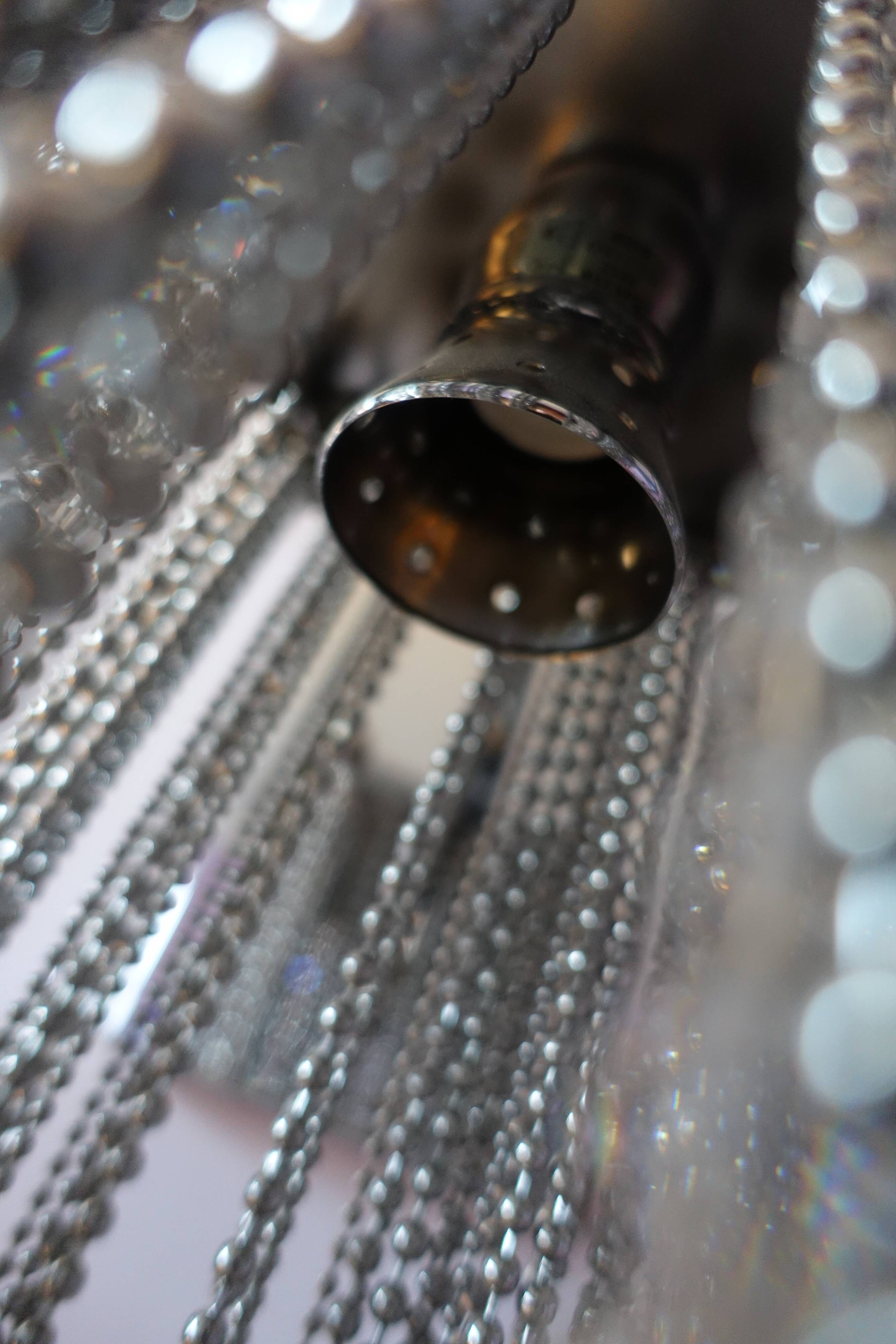 Swarovski wall lamp in silver-plated metal with crystal pendants.