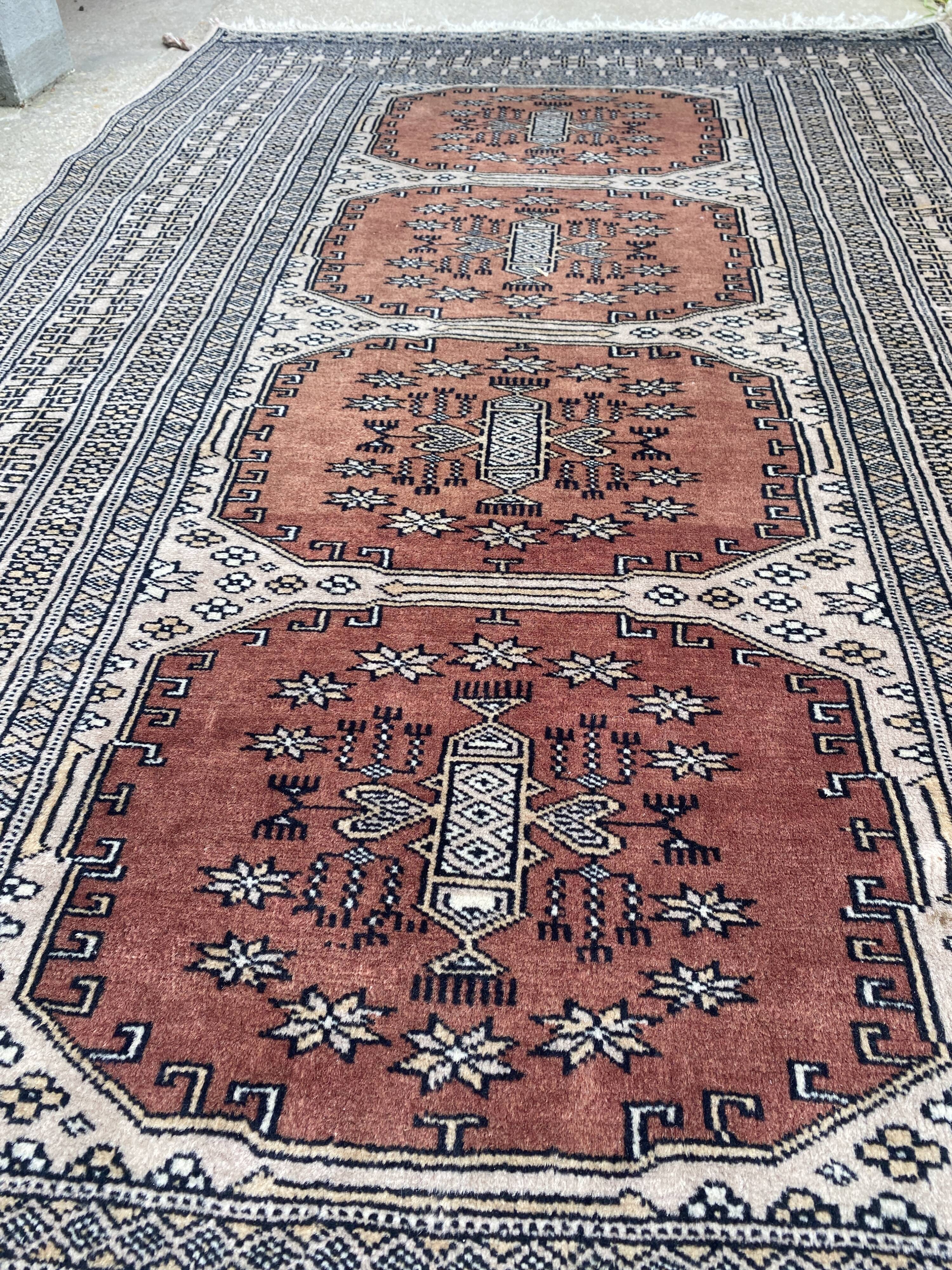 Vintage hand knotted rug with geometric patterns on a grey/beige/terracotta background 170 x 96 cm