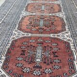 Vintage hand knotted rug with geometric patterns on a grey/beige/terracotta background 170 x 96 cm