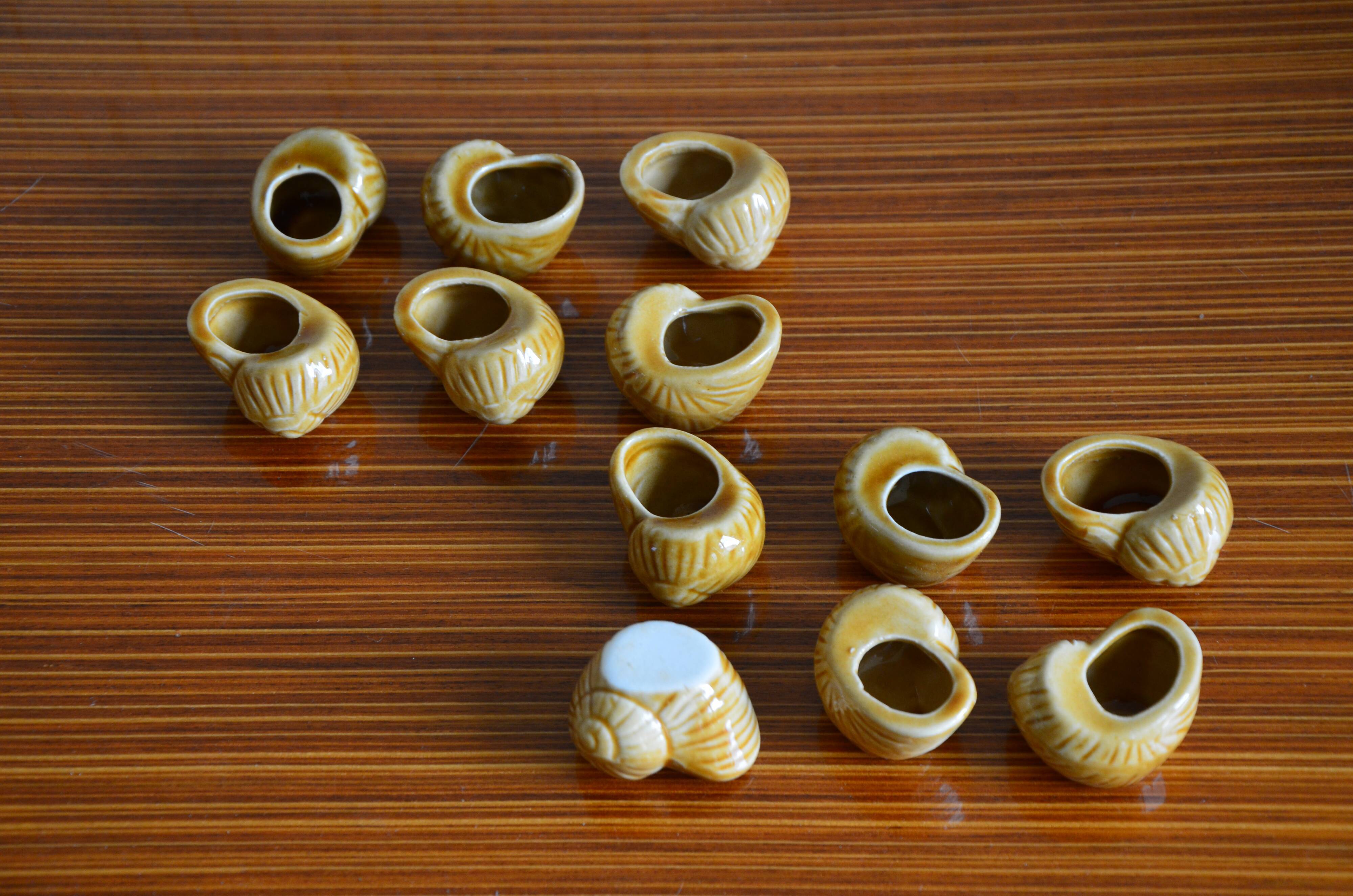 Lot of 12 enamelled sandstone snail shells