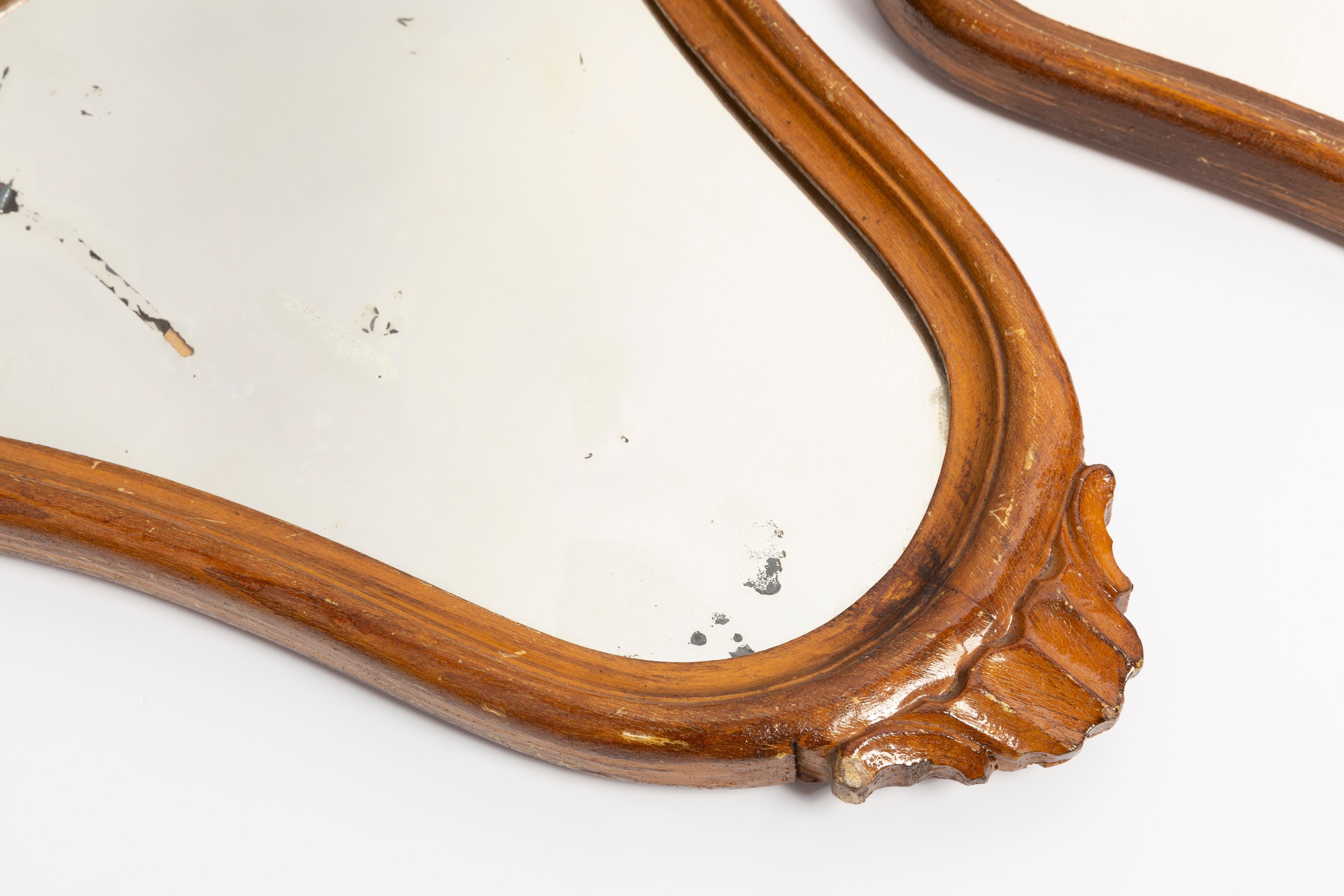Pair of vintage Mid-Century decorative mirrors in a gold frame, Italy, 1960s.