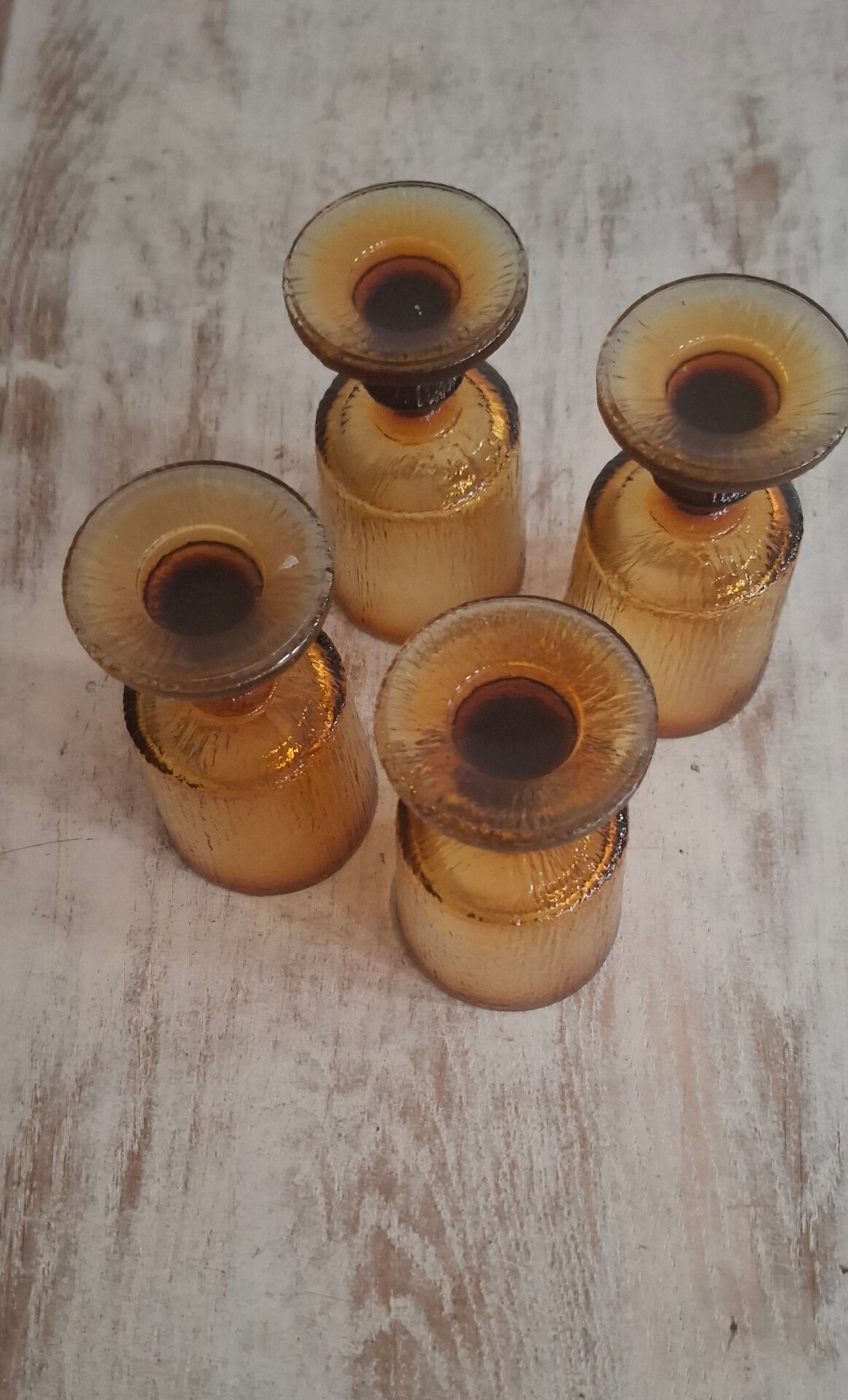 Set of four thick amber glass stemmed glasses.