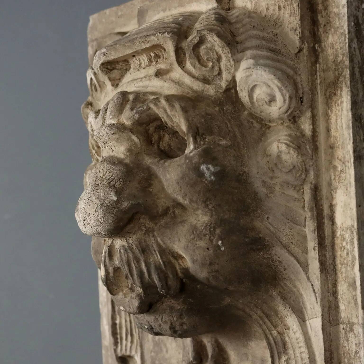 Old plaster tile with a fierce mask decoration, Italy, 19th century.