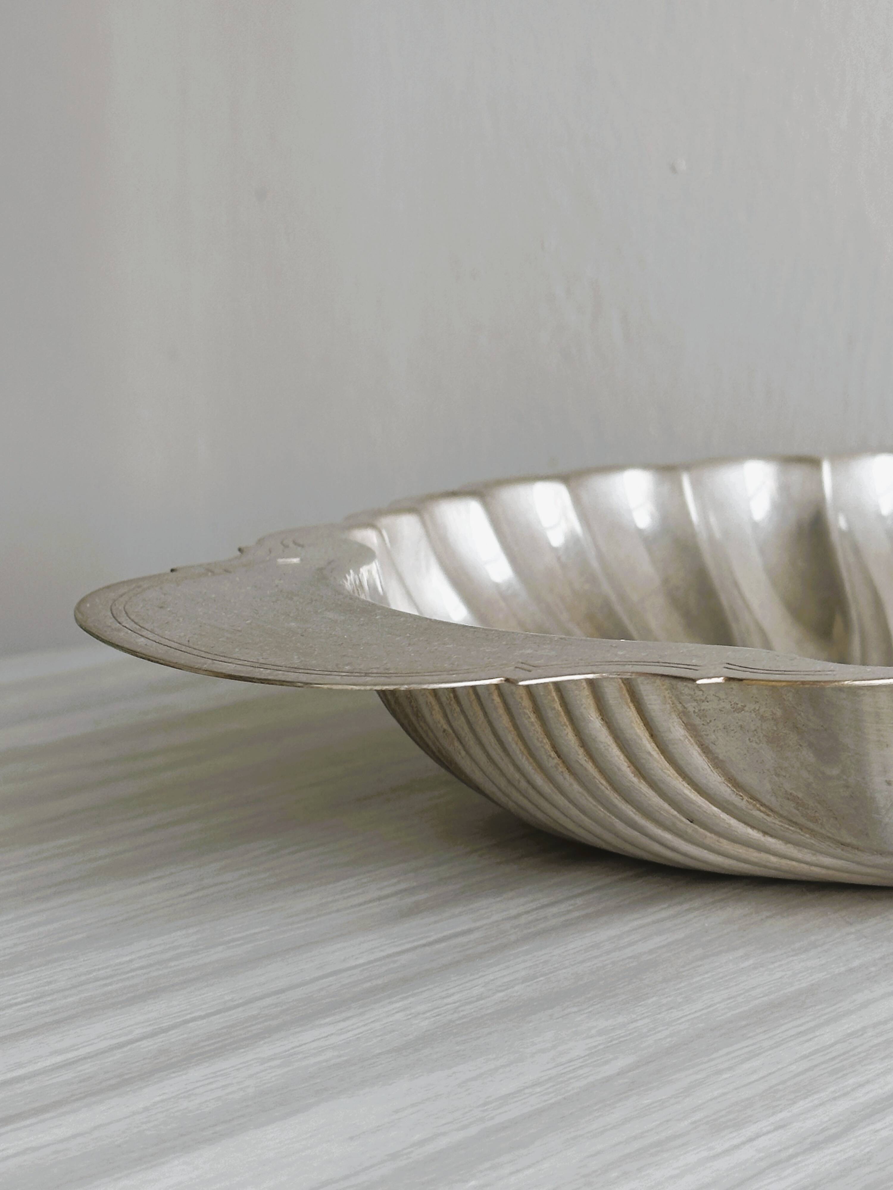 large silver-plated metal shell-shaped dish