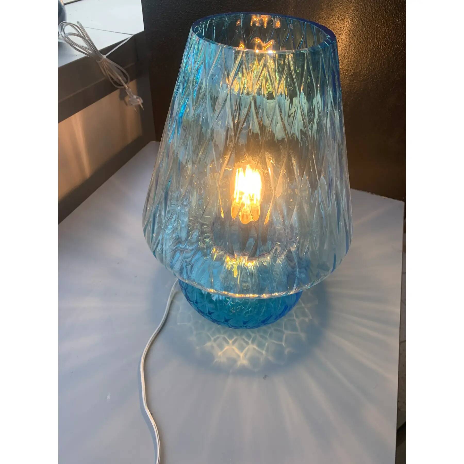 Light blue Murano-style glass with a balloton lamp.