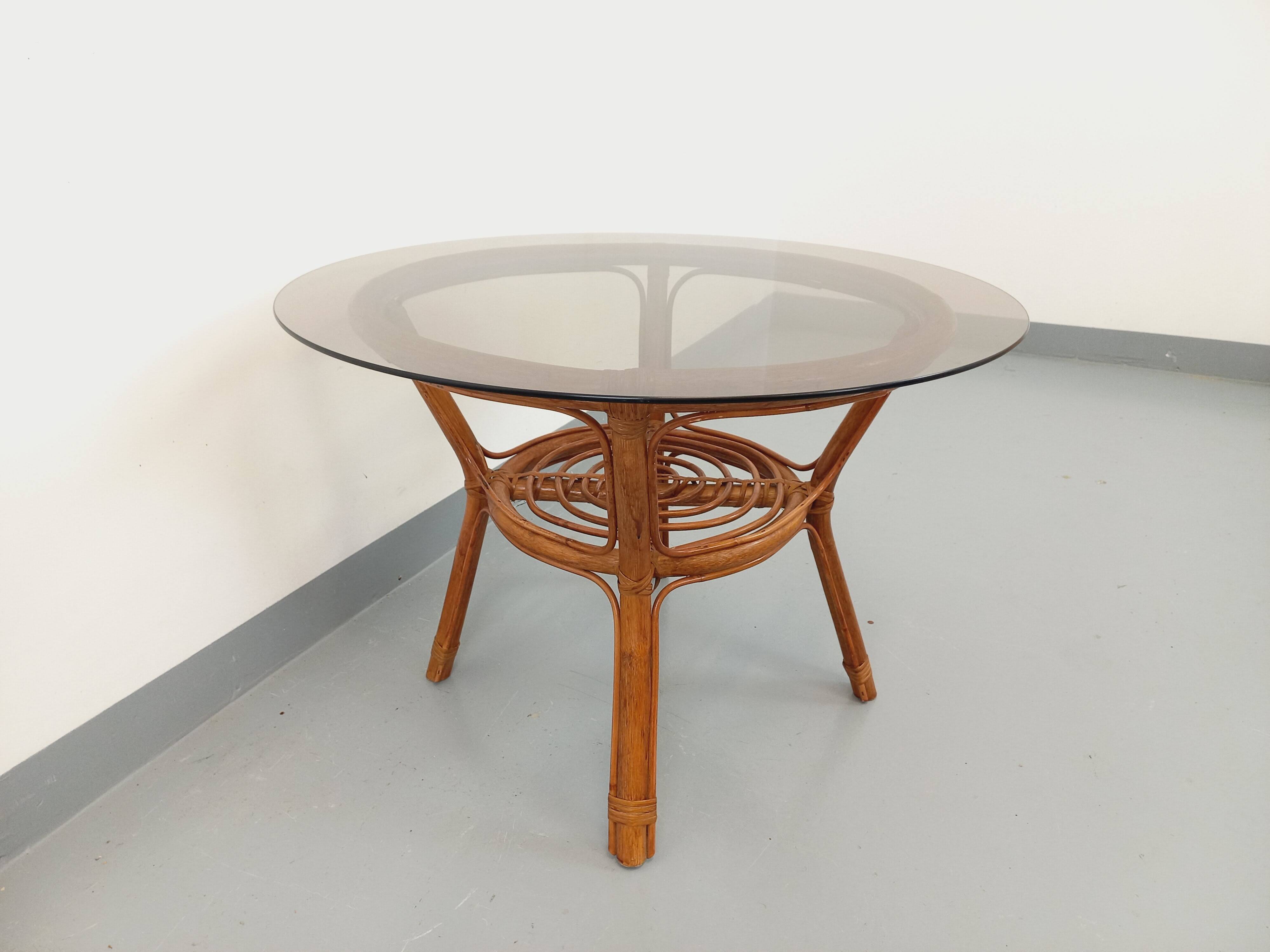 Vintage round smoked glass and rattan coffee table from the 70s