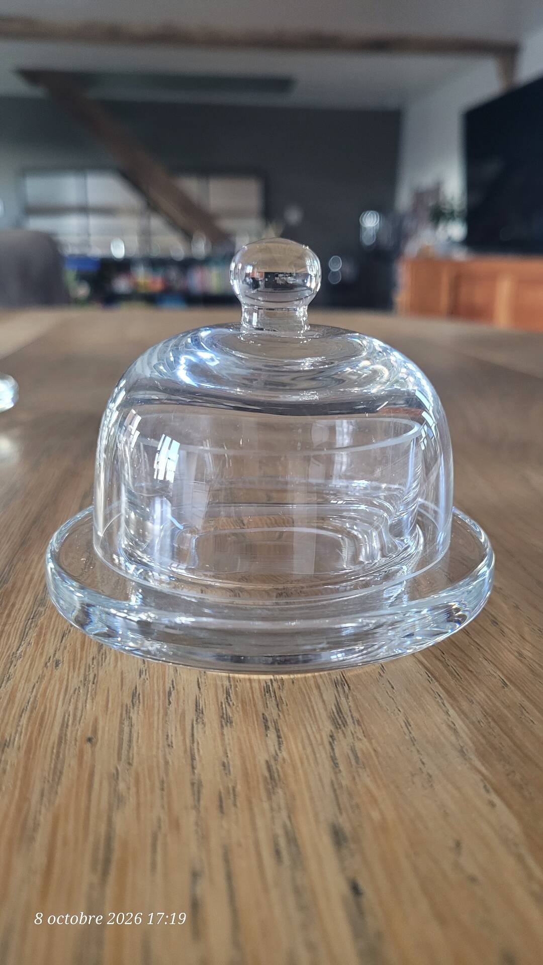 2 transparent glass butter dishes with their matching cloches.