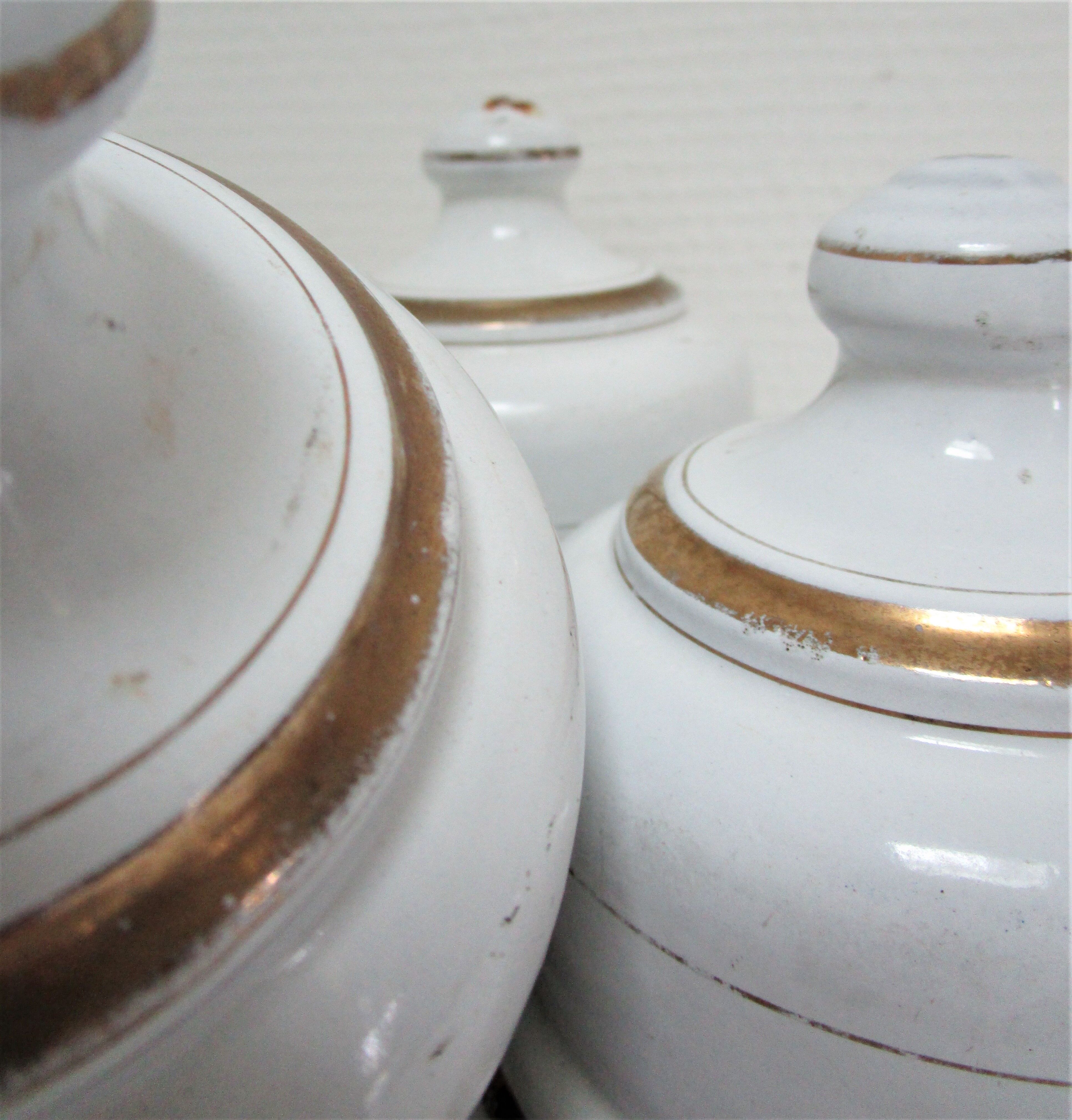 Four white enamelled metal cheese bells early twentieth century