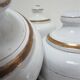Four white enamelled metal cheese bells early twentieth century