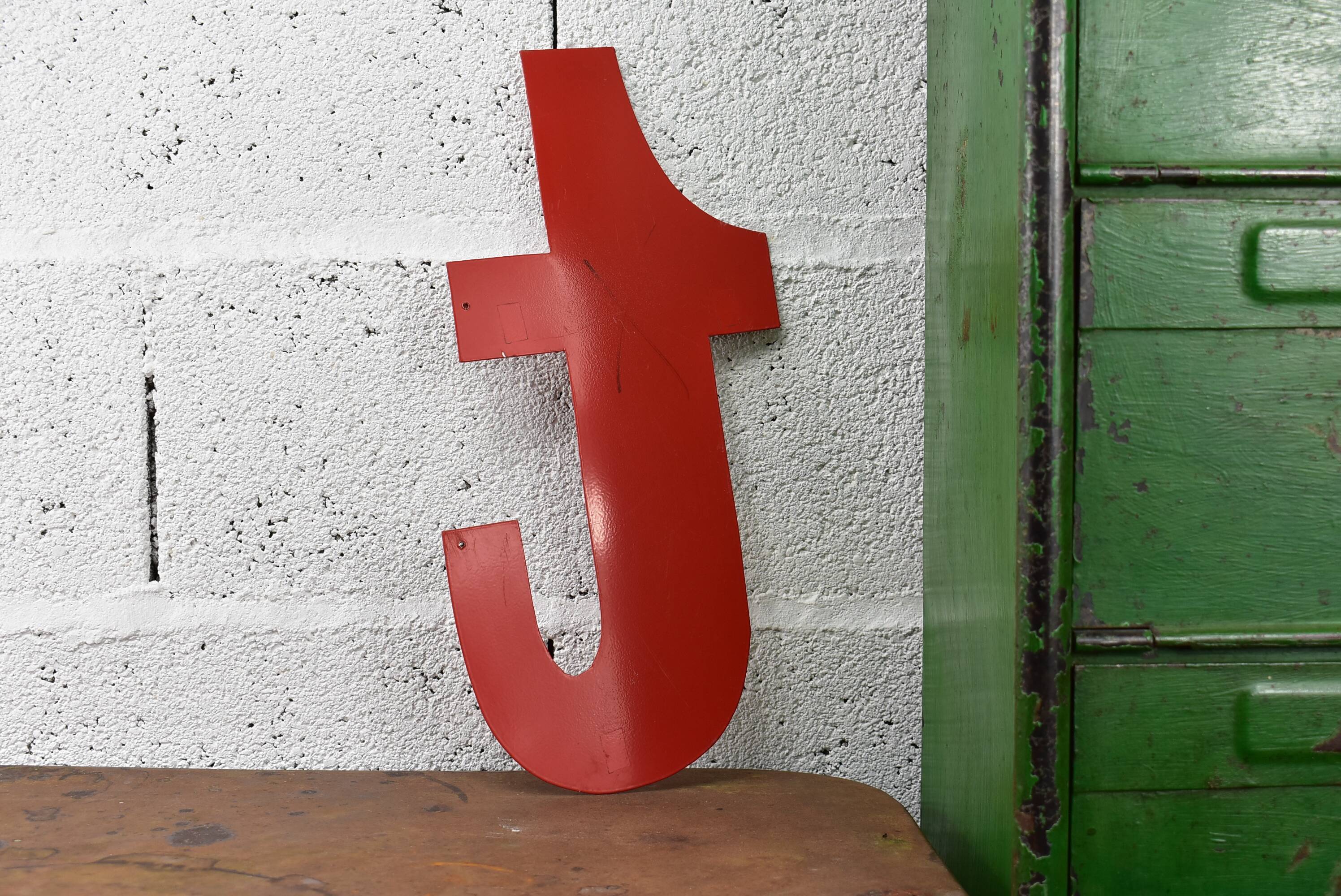 Industrial letter "t" in red metal