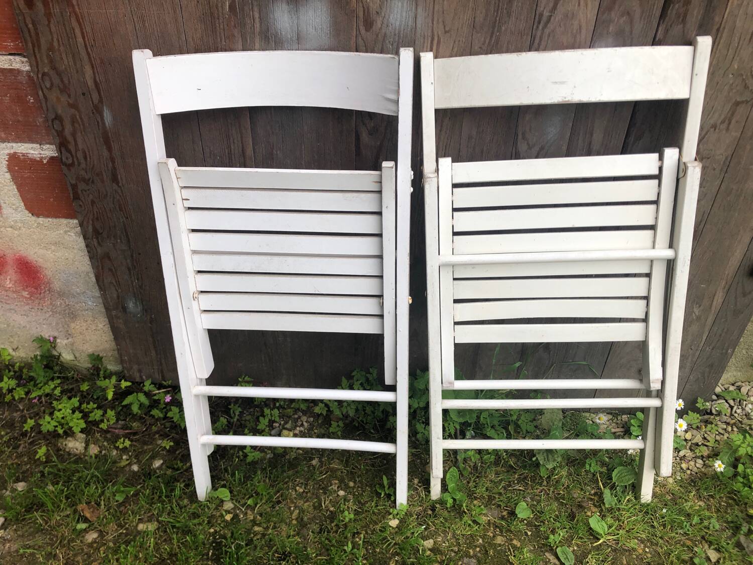 Pair of vintage white wooden folding chairs