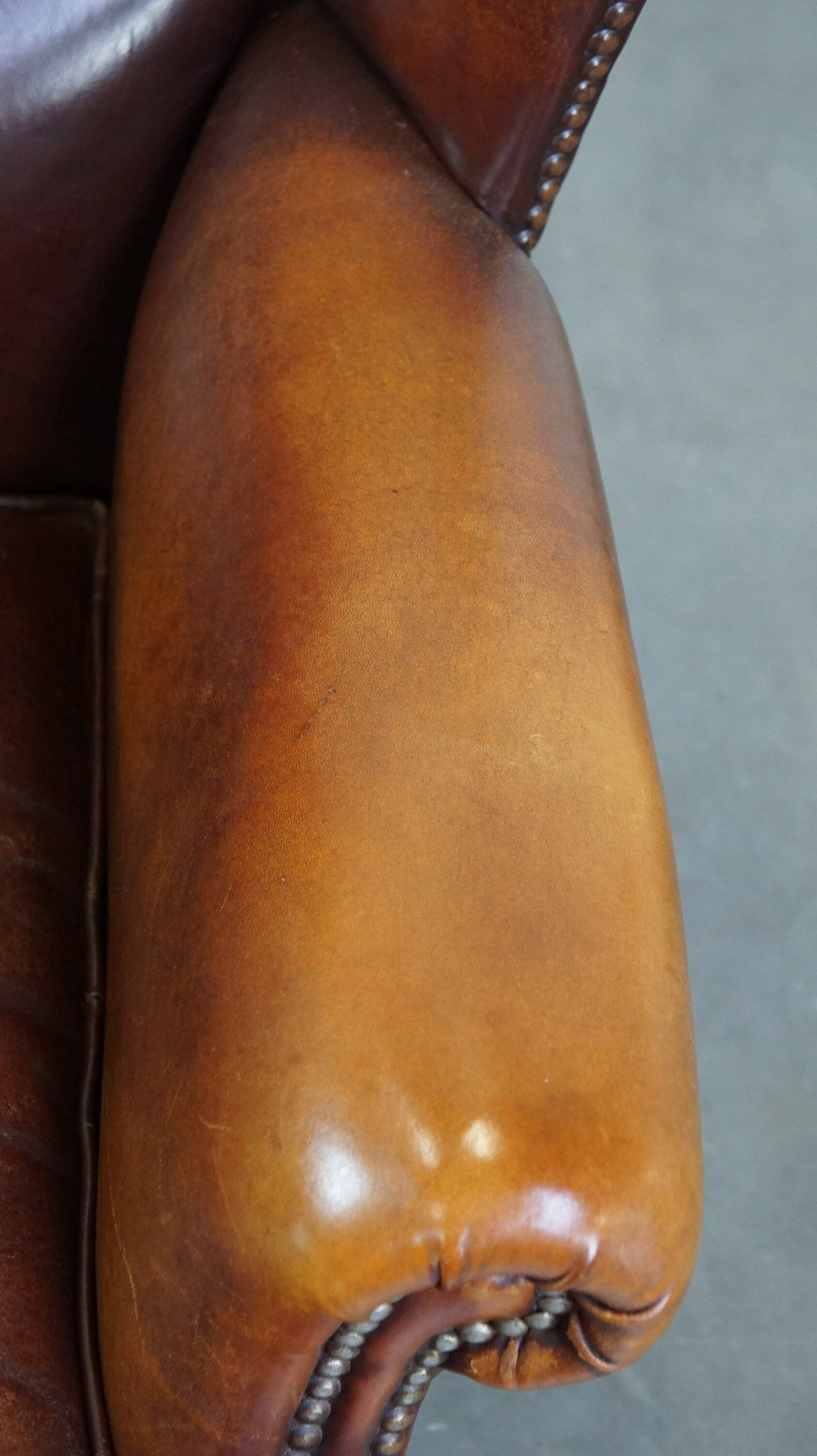 Comfortable, elegant, stately wing chair made of sheepskin in a beautiful warm color