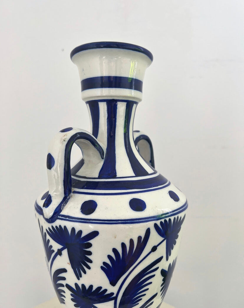 white amphora-style vase with hand-painted blue patterns