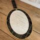 Vintage oval mirror with tartan decoration.
